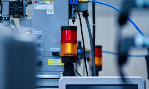 Detailed view of automated machinery with warning signals in an industrial setting.